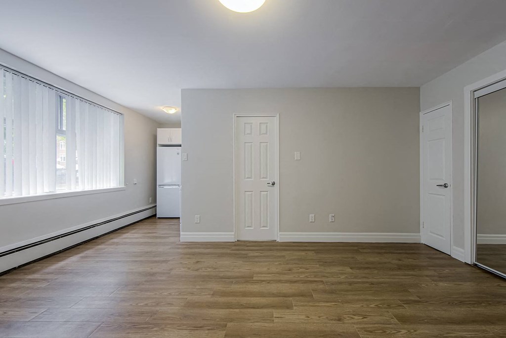a living room with wood floors and a white door at 107 Redpath, Toronto, M4S 2J9