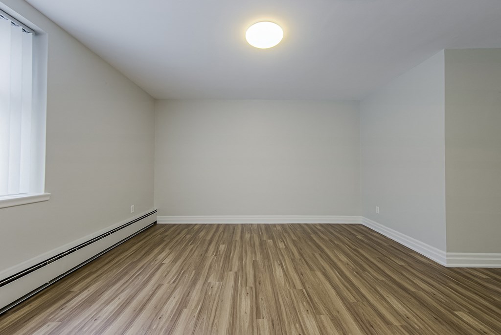 an empty room with wooden floors and white walls at 107 Redpath, Canada, M4S 2J9