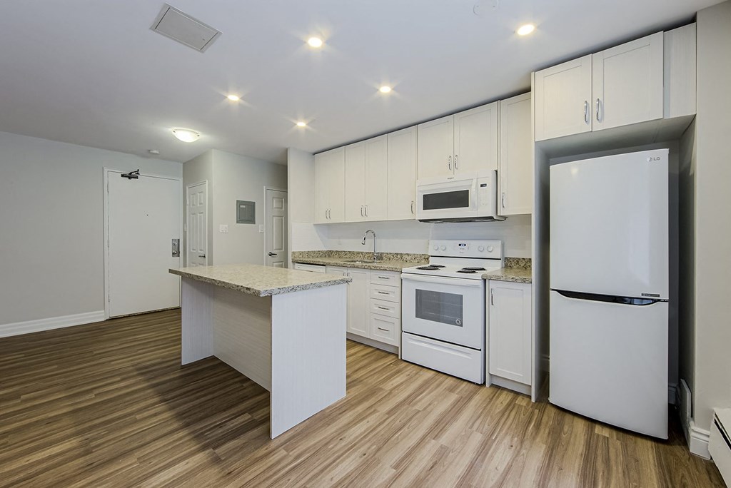 a kitchen with white appliances and a counter top at 107 Redpath, Toronto CA