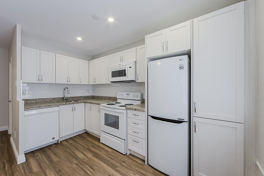 a kitchen with white cabinets and a refrigerator at 107 Redpath, Toronto, M4S 2J9
