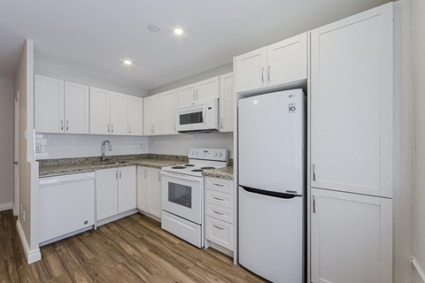 a kitchen with white cabinets and a refrigerator at 107 Redpath, Toronto, M4S 2J9