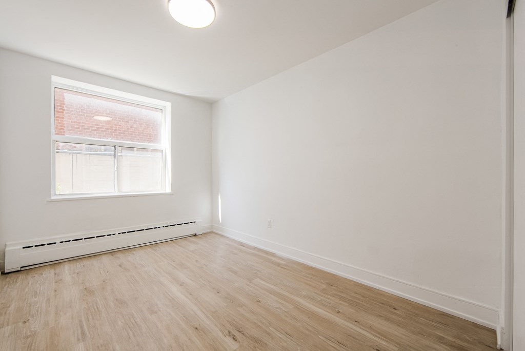 an empty room with white walls and a window at 111 Cosburn, East York, M4J 2L1