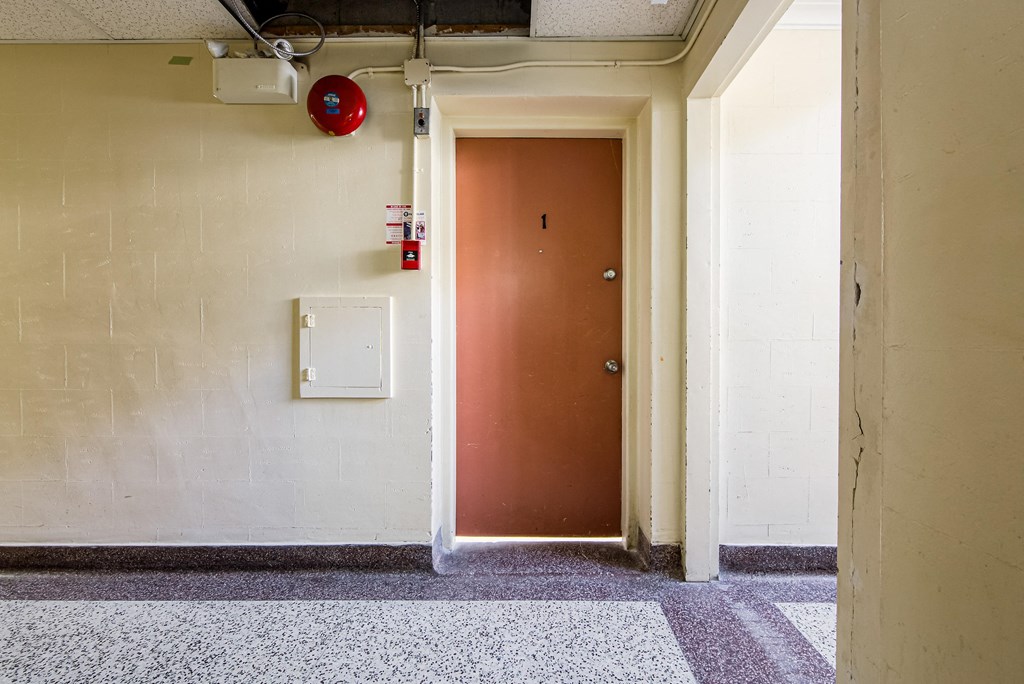 the door to a room in a building with a red door at 111 Cosburn, Ontario, M4J 2L1