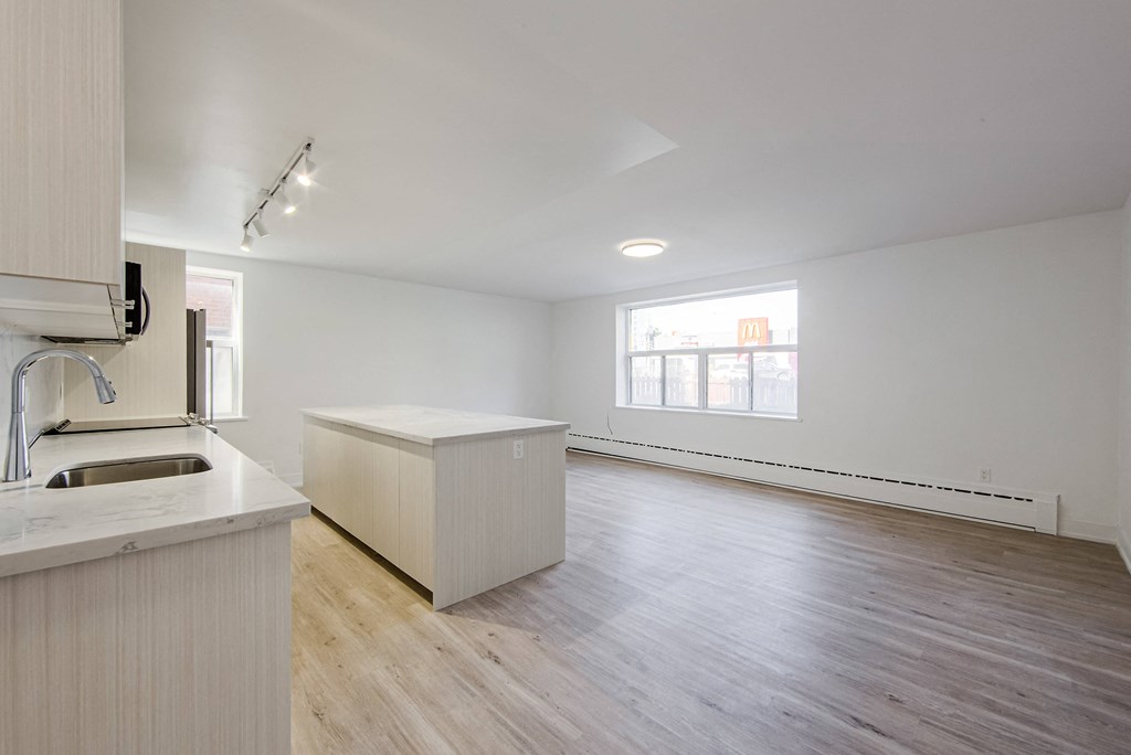 an empty kitchen and living room with a large window at 111 Cosburn, East York, ON M4J 2L1