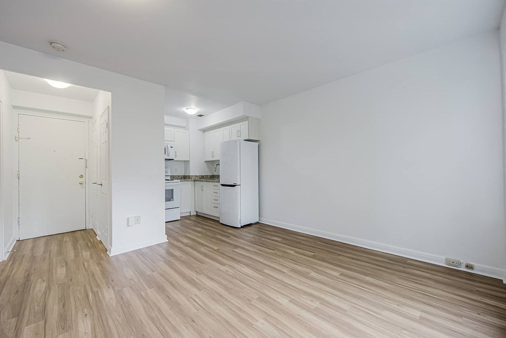 a living room and kitchen with a wood floor at 161 St. George, Toronto