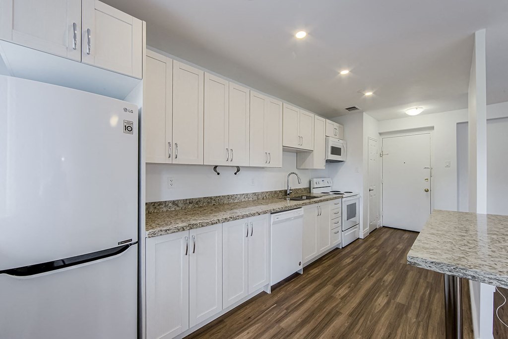 a kitchen with white cabinets and a counter top at 161 St. George, Toronto, CA