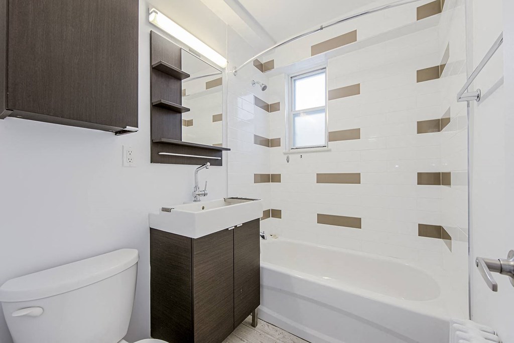 a bathroom with a toilet sink and bath tub at 161 St. George, Toronto, CA M5R 2M3
