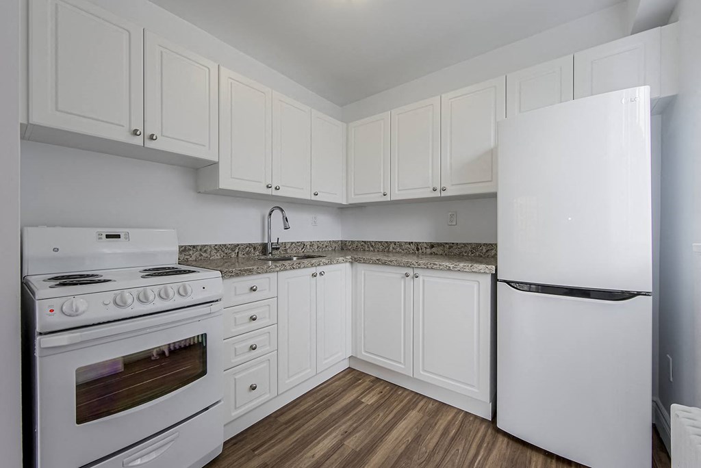 a kitchen with white appliances and white cabinets at 161 St. George, Toronto Canada