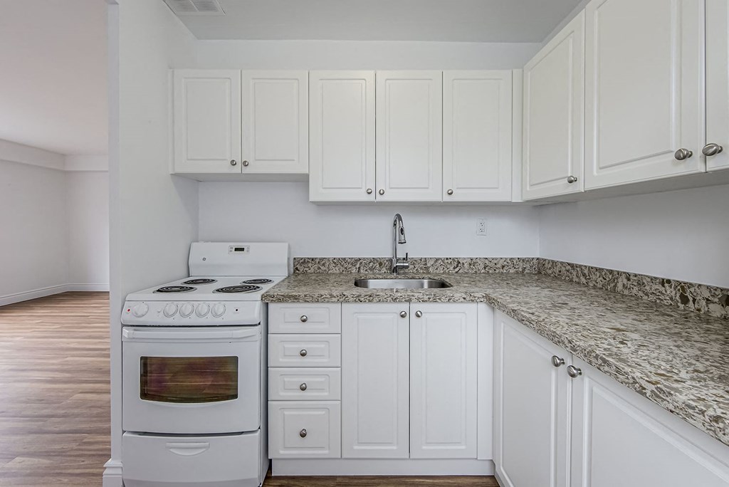 a kitchen with white appliances and white cabinets at 161 St. George, Canada, M5R 2M3