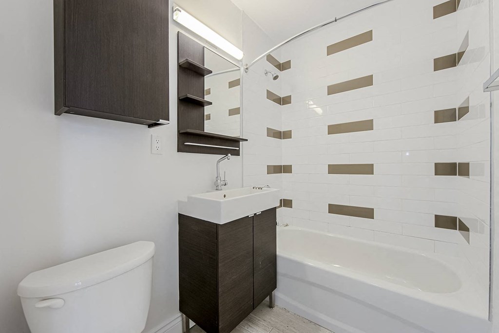 a white bathroom with a toilet and a sink at 161 St. George, Toronto, CA