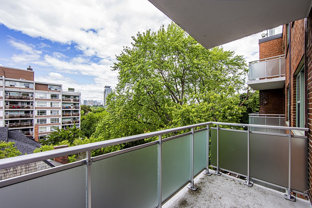 a balcony with a view of the city and trees at 161 St. George, Canada, M5R 2M3
