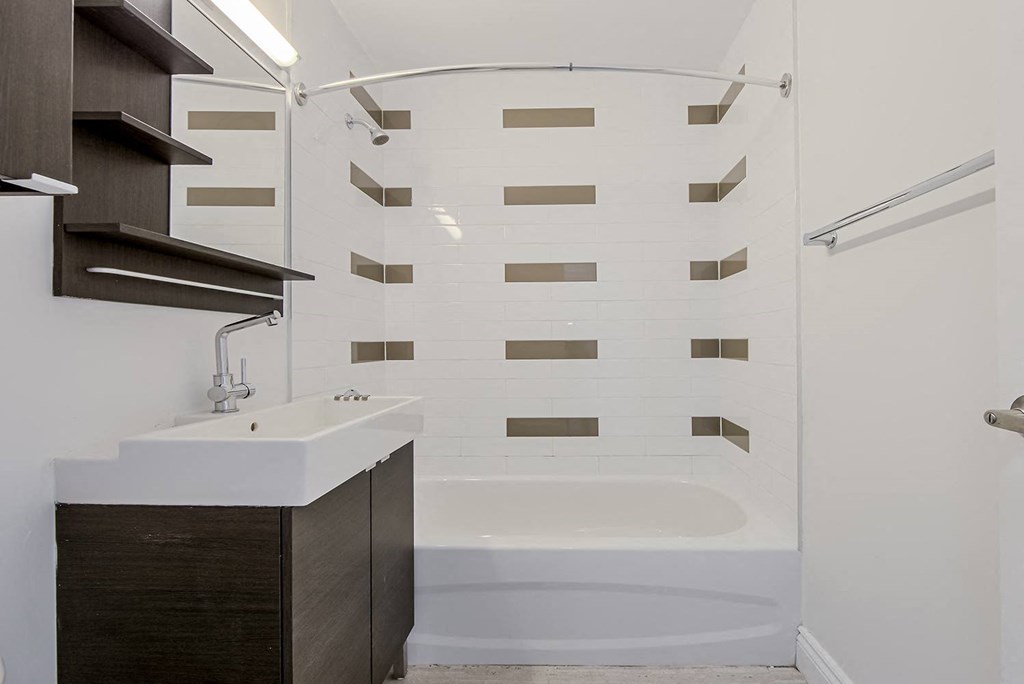 a small bathroom with a shower and a sink at 161 St. George, Toronto, M5R 2M3