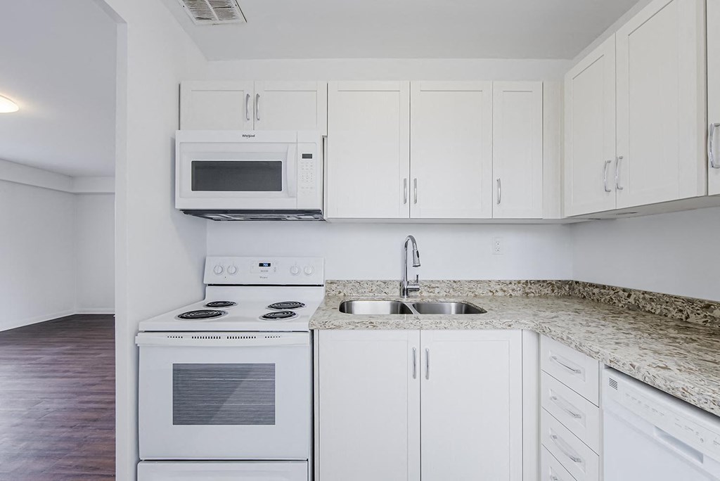 a kitchen with white appliances and white cabinets at 161 St. George, Toronto