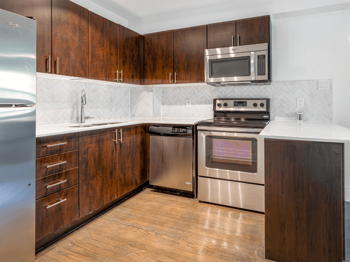 A kitchen with wooden cabinets and stainless steel appliances.