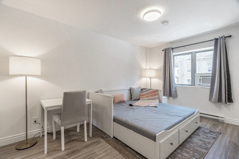 a bedroom with a bed and a desk and a window at 608 Church Apartments, Toronto, ON, M4Y 2E7