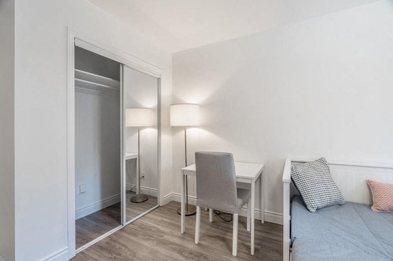 a bedroom with a bed and a desk and a mirror at 608 Church Apartments, Toronto, ON, M4Y 2E7