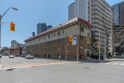 a building on the corner of a street with a traffic light