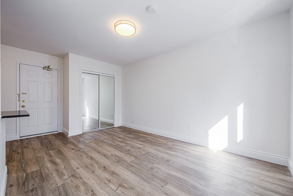 A room with a white door and a window at 608 Church Apartments, Toronto, ON