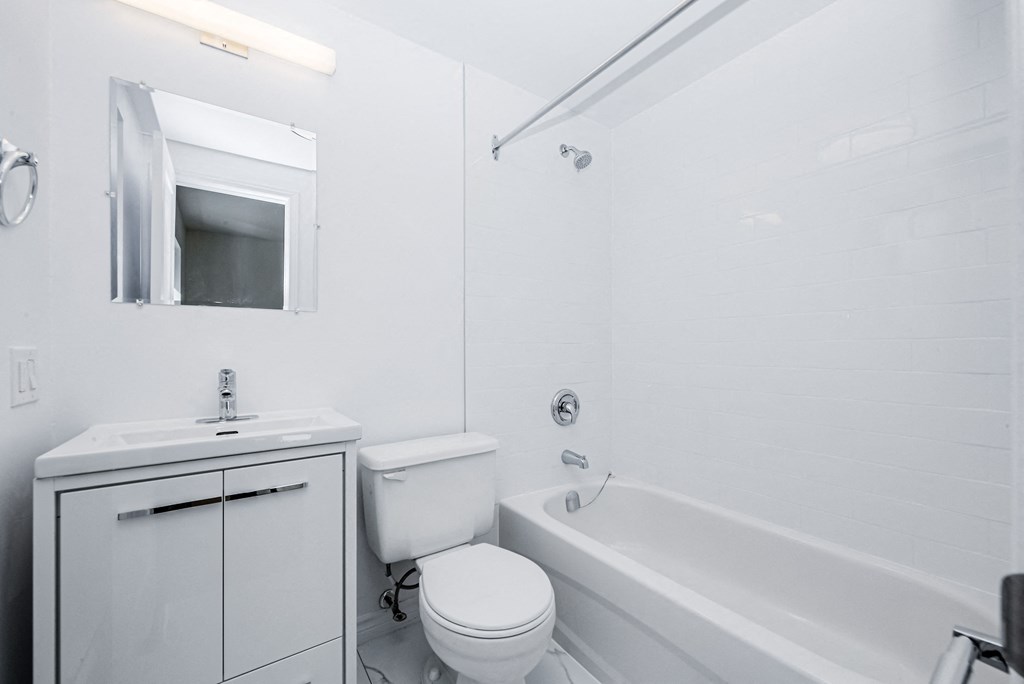 a white bathroom with a sink toilet and bath tub at 608 Church Apartments, Toronto, ON, M4Y 2E7