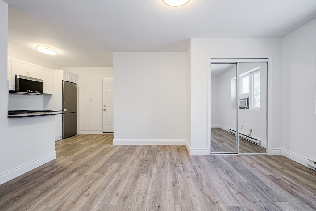 an empty living room with white walls and wood flooring at 608 Church Apartments, Ontario, M4Y 2E7