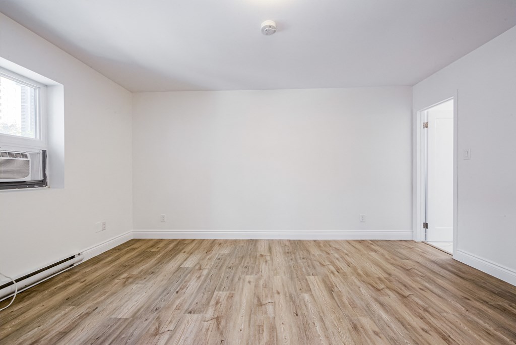 A room with wooden flooring and white walls. at 608 Church Apartments, Toronto, ON, M4Y 2E7