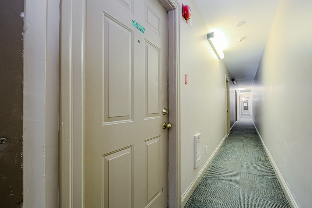 a hallway with white doors and a door knob in the middle of it at 608 Church Apartments, Toronto
