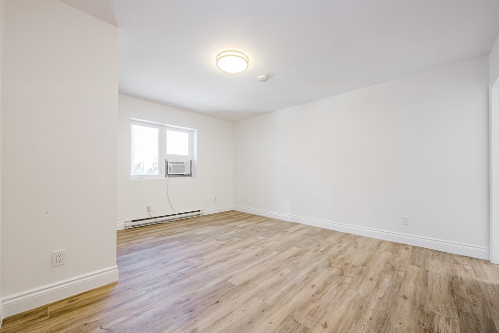 A room with wooden flooring and a window. at 608 Church Apartments, Ontario