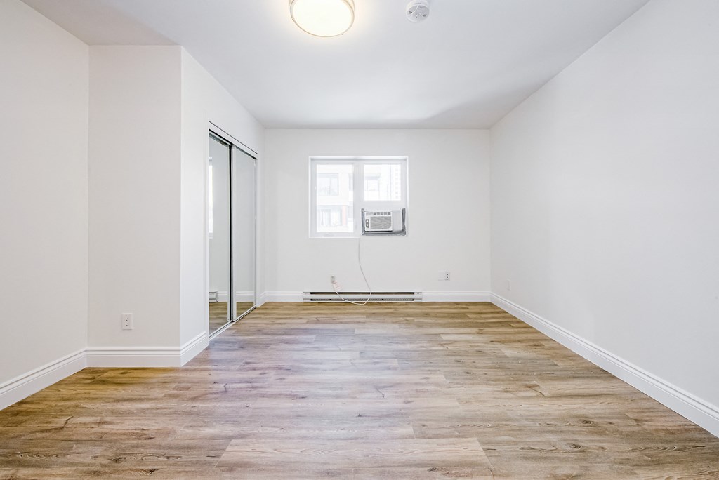 A room with wooden flooring and a window at 608 Church Apartments, Ontario, M4Y 2E7
