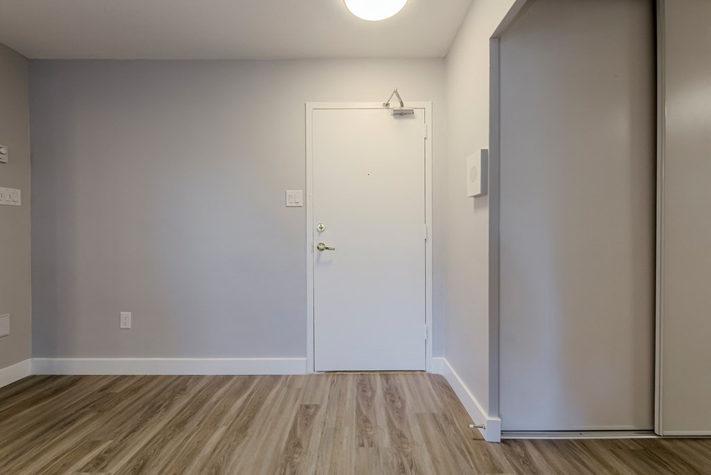 an empty room with white walls and a door at 70 Park, Mississauga
