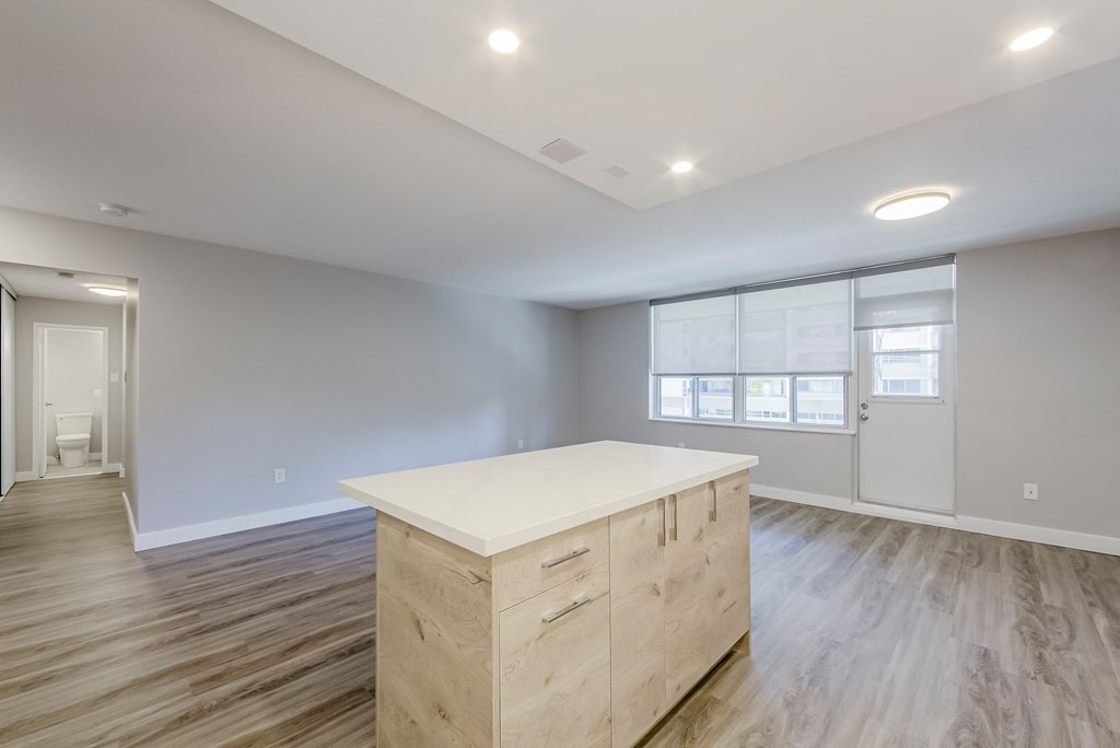 a kitchen island in a new home at 70 Park, Mississauga with a white counter top