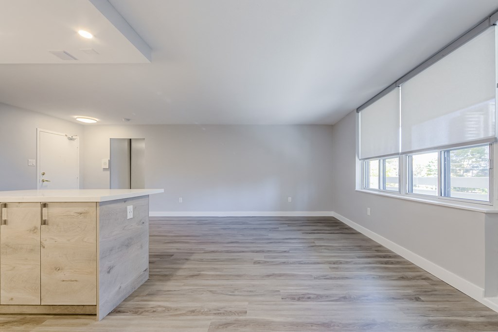an empty living room with white walls and a large window at 70 Park, Mississauga, Canada