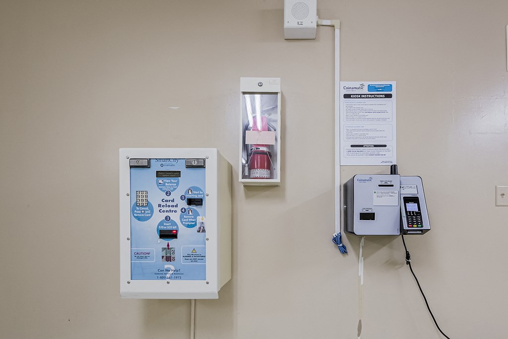 a phone and a machine on a wall at 70 Park, Mississauga, CA