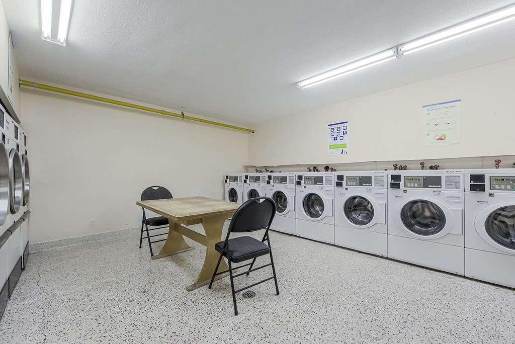a laundry room with a table and chairs and washing machines at 70 Park, Canada, L5G 1M5