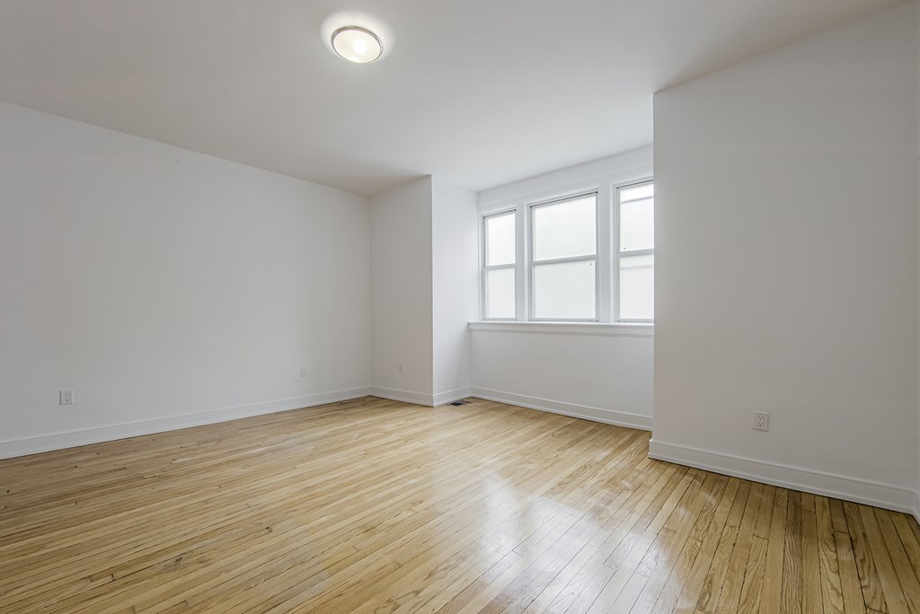 A room with wooden flooring and a window at 723 Bloor Apartments, Toronto