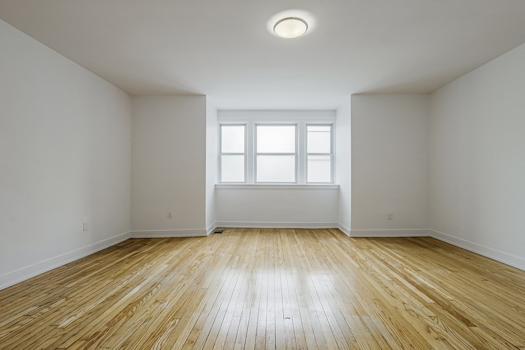 an empty room with wood floors and a window at 723 Bloor Apartments, Toronto, M6G 1L5