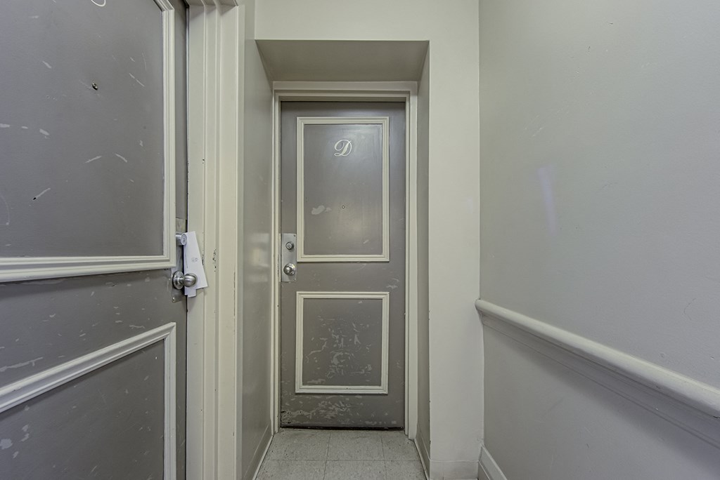 a door in a hallway of a building with a grey door at 723 Bloor Apartments, Toronto, Canada