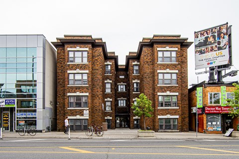 A brick building with a bicycle parked in front of it.