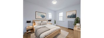 A bedroom with a large bed, a nightstand with a lamp, and a plant on the side table. at 83-85 Silver Birch, Toronto Canada