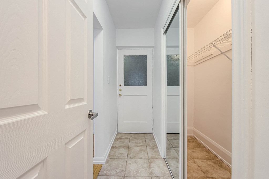 a hallway with a white door and a closet at 83-85 Silver Birch, Canada, M4E 3L2