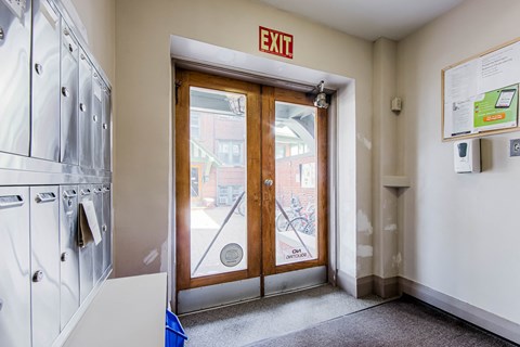 a laundry room with a door and a exit sign at 83-85 Silver Birch, Toronto Canada
