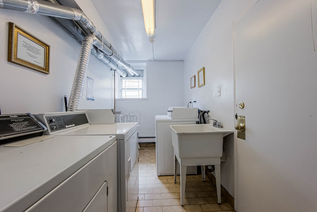 a kitchen with white appliances and a sink and a window at 83-85 Silver Birch, Toronto, CA