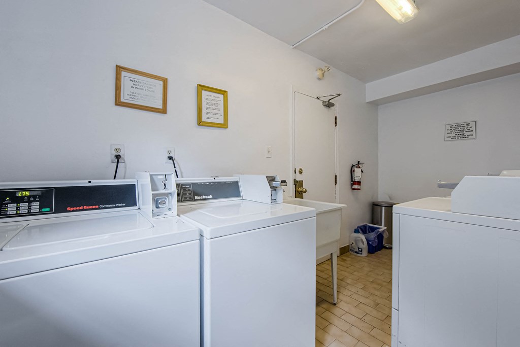 a laundry room with two washes and two dryers in it at 83-85 Silver Birch, Canada, M4E 3L2