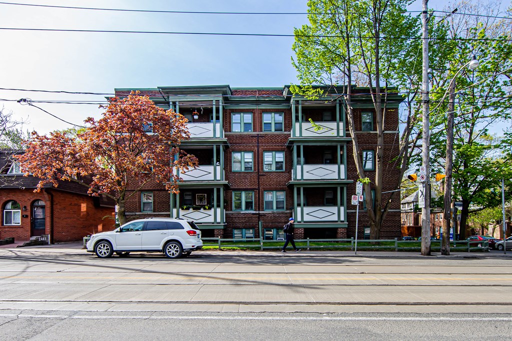 a car parked on a street in front of an apartment building at 83-85 Silver Birch, Toronto, CA M4E 3L2
