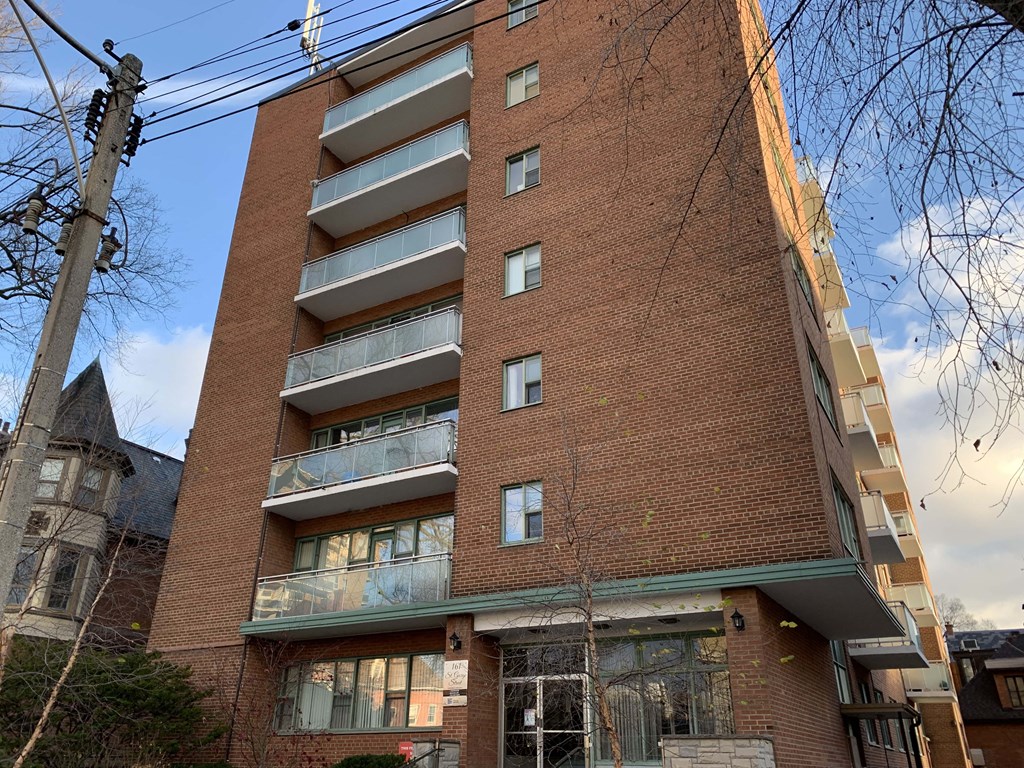 an apartment building with a red brick facade and balconies at 161 St. George, Toronto, CA M5R 2M3