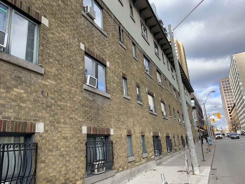 an old brick building on a city street at 608 Church Apartments, Toronto, ON