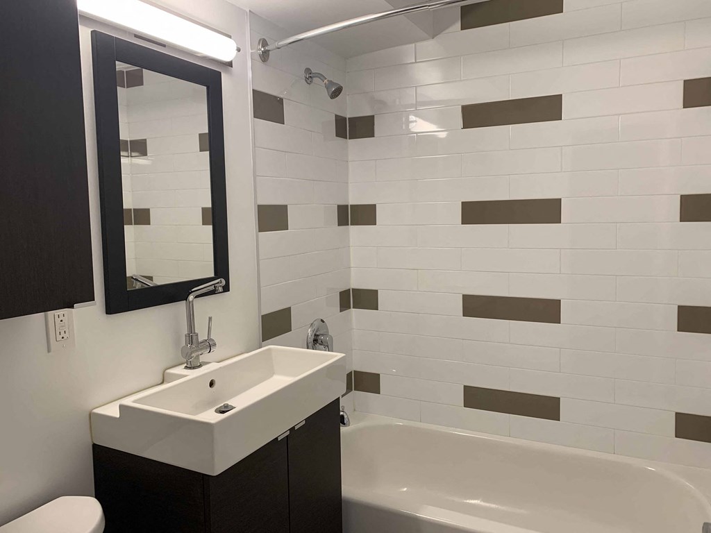 a small bathroom with a sink and a bath tub