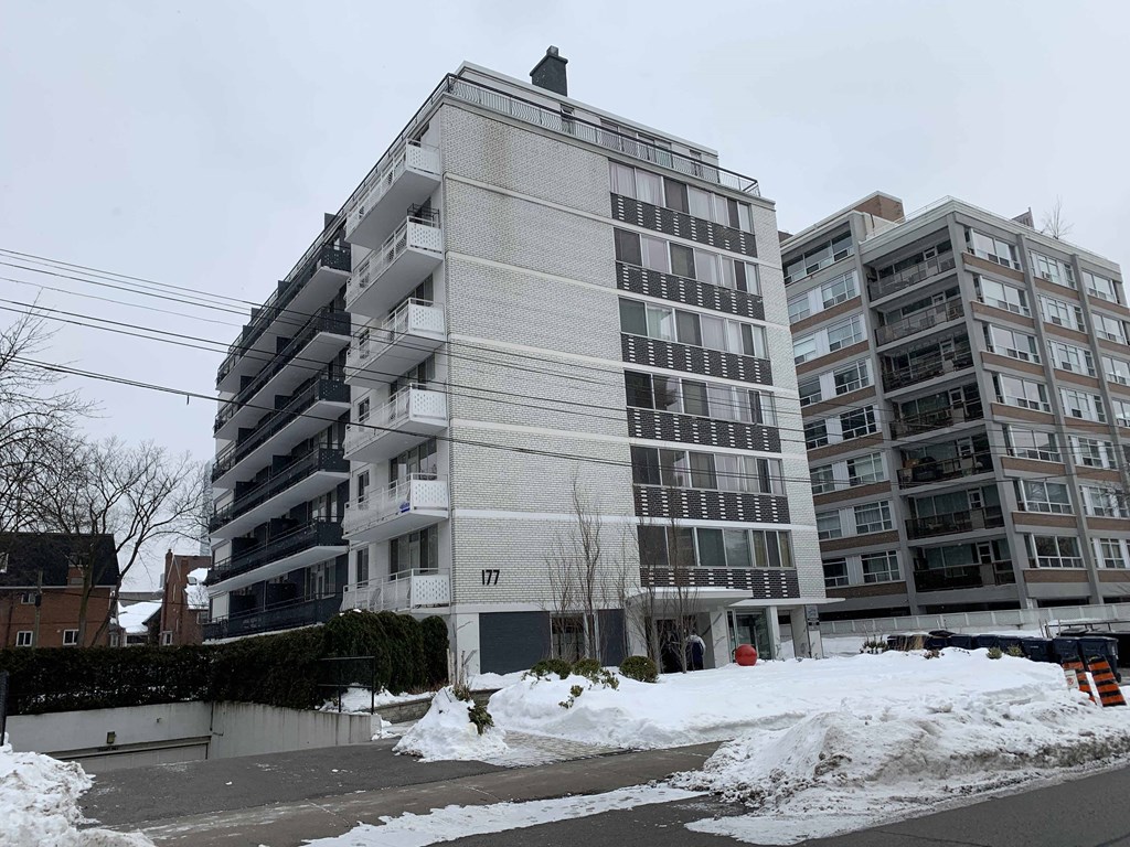 a building in a city with snow on the street