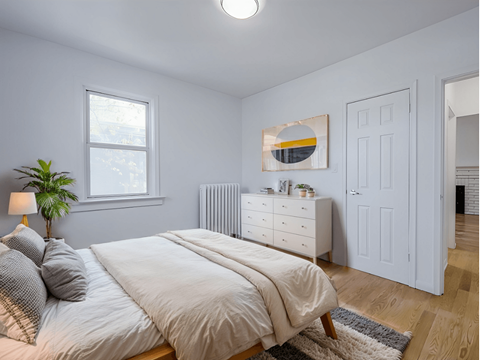 A bedroom with a bed, nightstand, and a painting on the wall. at 83-85 Silver Birch, Toronto Canada