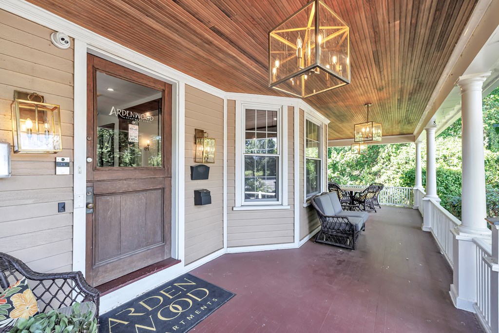 A wooden deck with a bench and a chandelier.