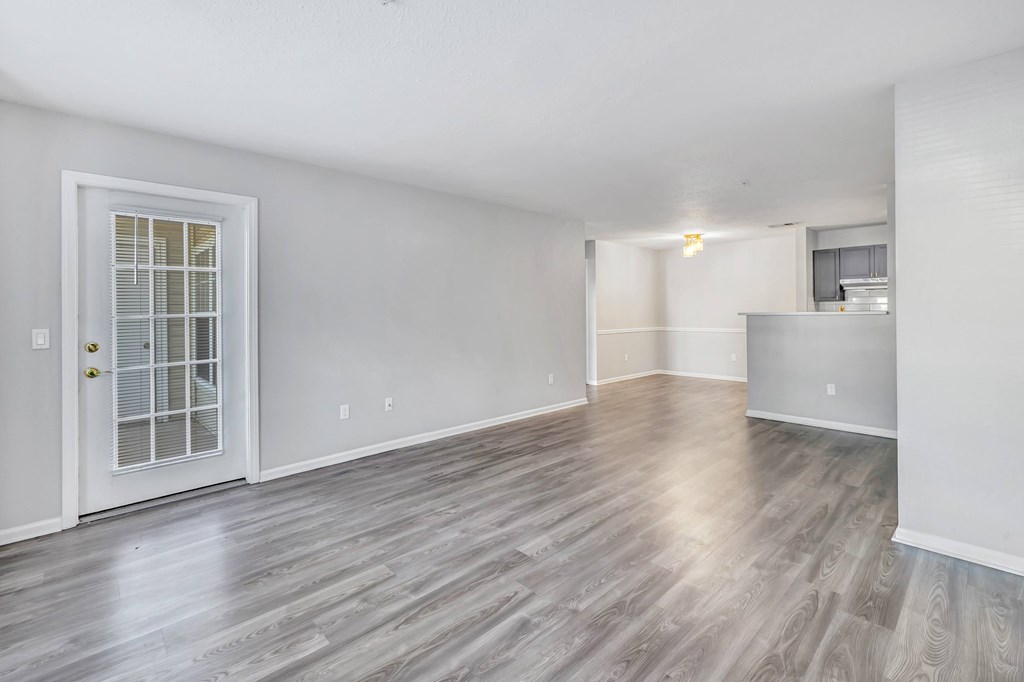 A room with a wooden floor and a white door.